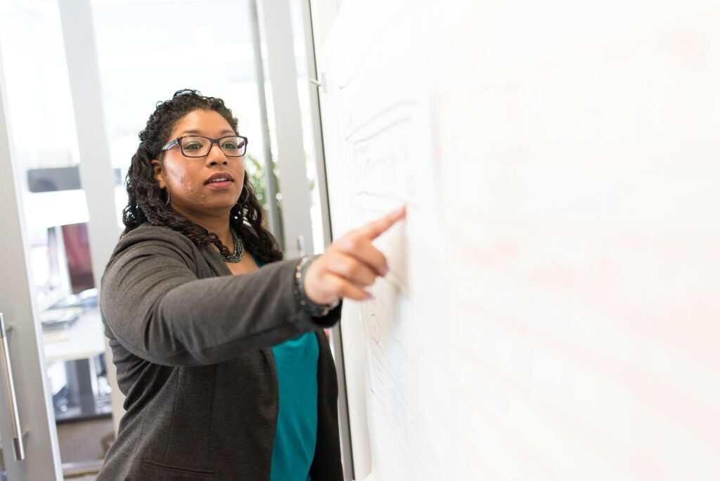 Confident businesswoman making a point during a presentation in an office setting.
