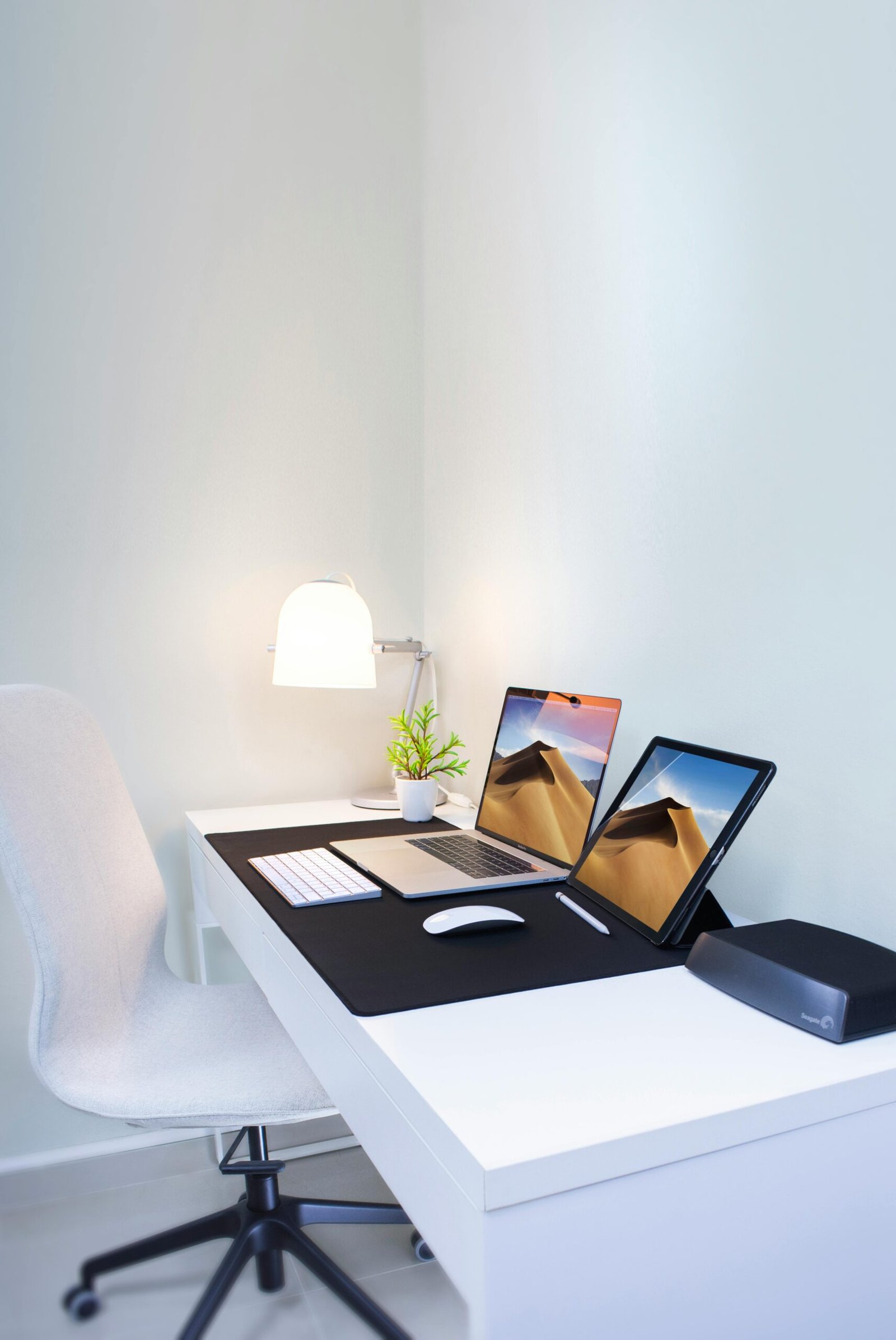 Stylish home office desk with dual screens and minimalist decor. Perfect for remote work and productivity.